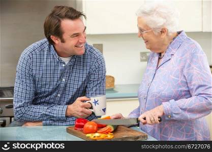 Mother and adult son preparing meal together