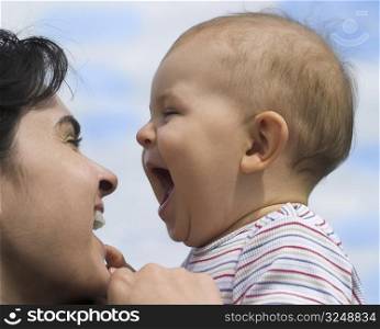 Mother and baby are laughing together.
