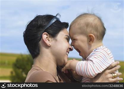 Mother and baby are laughing together.