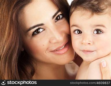 Mother and baby closeup portrait, happy faces, Arabic family picture, adorable small boy, mom and kid having fun indoor, parents joy, holding little child, healthy toddler and mommy, happiness concept