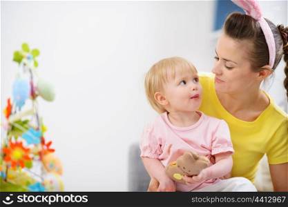 Mother and baby eating chocolate Easter rabbit cookie