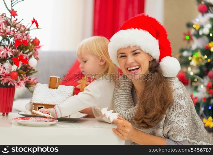 Mother and baby enjoying Christmas cookies