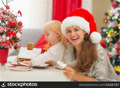 Mother and baby enjoying Christmas cookies