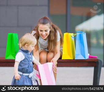 Mother and baby examines purchases after shopping