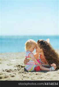 Mother and baby girl playing on beach