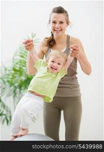 Mother and baby having fun in gym