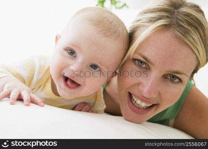 Mother and baby indoors smiling