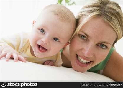 Mother and baby indoors smiling