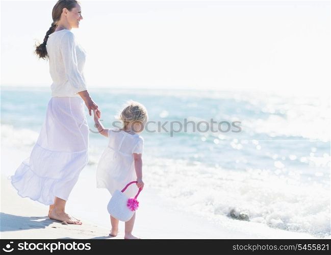 Mother and baby looking at sea