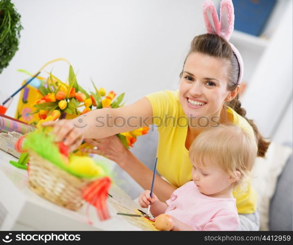 Mother and baby making easter decoration
