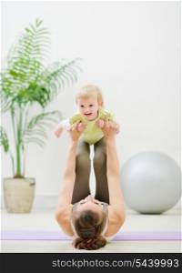 Mother and baby making gymnastics