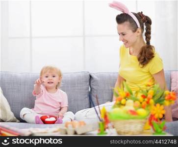 Mother and baby making preparations for Easter