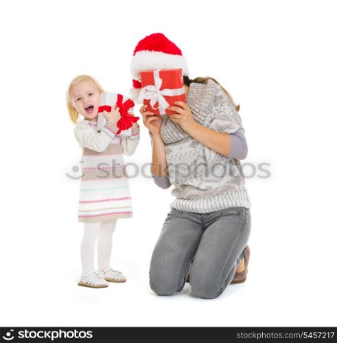 Mother and baby playing with Christmas present boxes