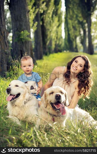 Mother and baby playing with dogs