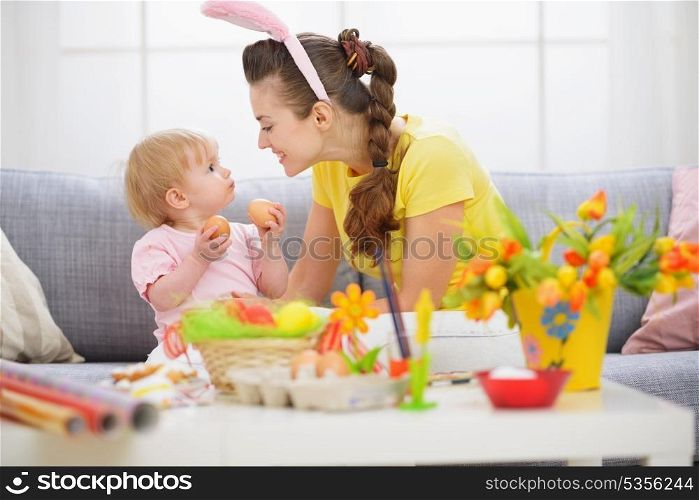 Mother and baby playing with Easter eggs