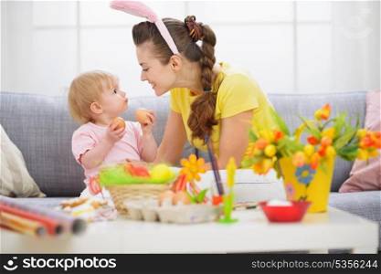 Mother and baby playing with Easter eggs