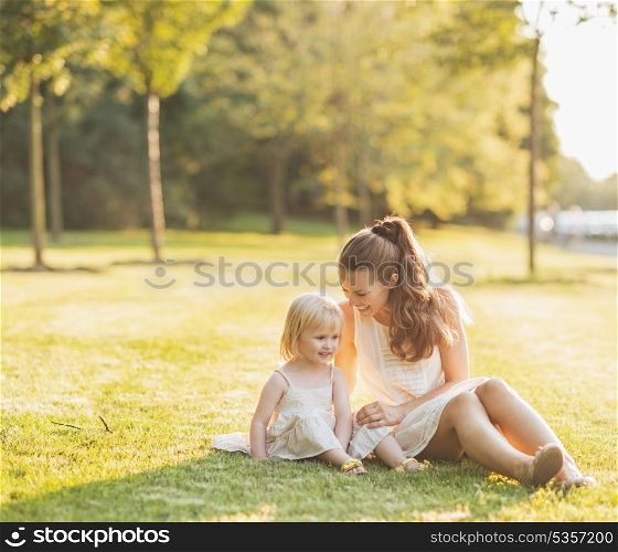 Mother and baby relaxing in park