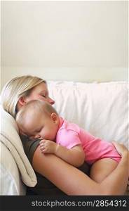 Mother and Baby Sleeping on Sofa
