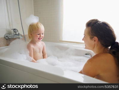 Mother and baby taking bath