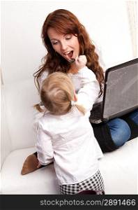 Mother and baby with laptop