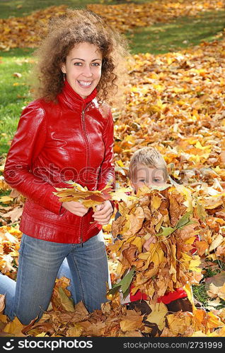 mother and child among fallen leaves