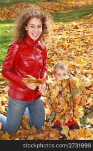 mother and child among fallen leaves