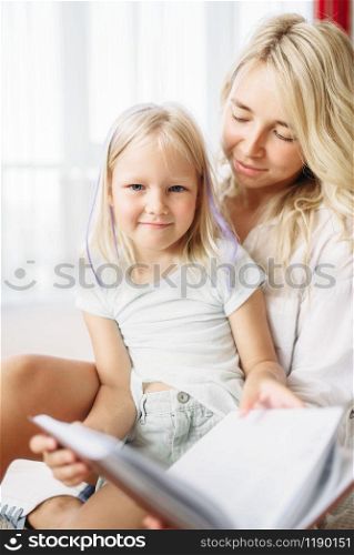 Mother and child have fun together lying on the floor at home. Parent feeling, togetherness. Mother and child have fun together at home