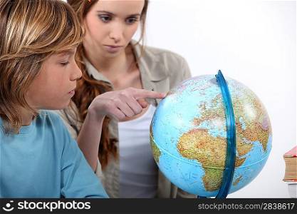 Mother and child looking at a globe