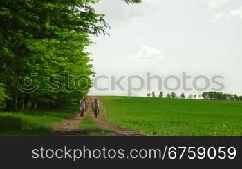 Mother and child riding bikes down a country lane