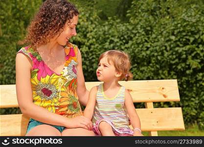 mother and child sit on bench