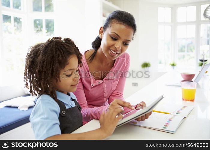 Mother And Child Using Digital Tablet For Homework