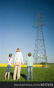 Mother and children by pylon