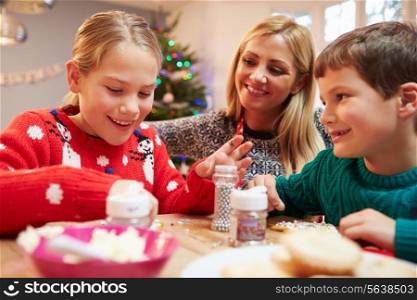 Mother And Children Decorating Christmas Cookies Together