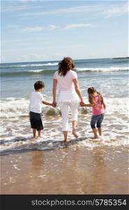 Mother And Children Having Fun On Beach Holiday