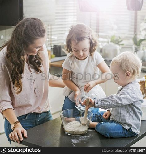 Mother and children making a birthday cake