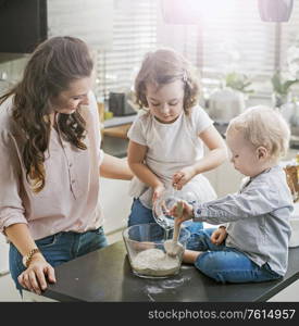 Mother and children making a birthday cake