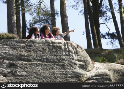 Mother And Children Resting On Hike Through Countryside