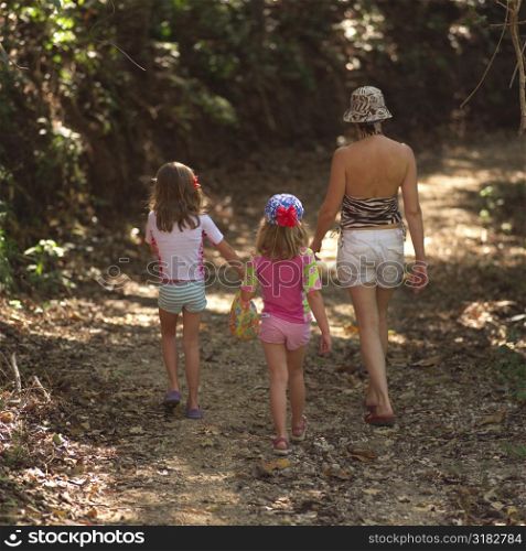 Mother and children walking through forest