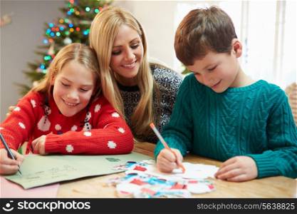 Mother And Children Writing Letter To Santa Together