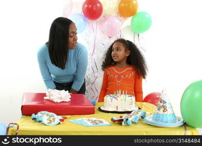 Mother and daughter at birthday table.
