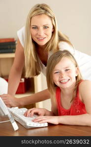 Mother And Daughter At Home Using Computer