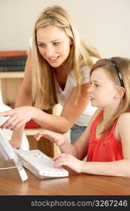 Mother And Daughter At Home Using Computer