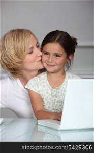 Mother and daughter at laptop computer