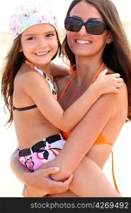 Mother and daughter at the beach together