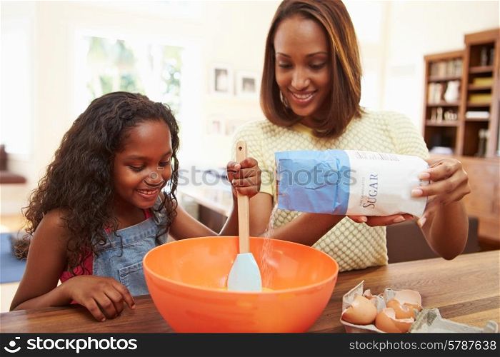 Mother And Daughter Baking Together At Home