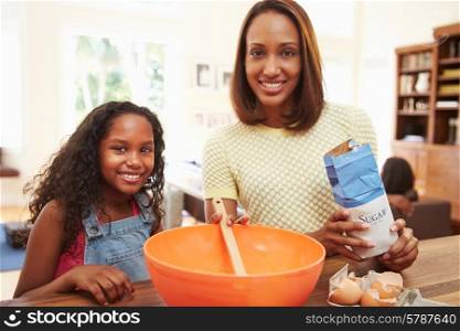 Mother And Daughter Baking Together At Home