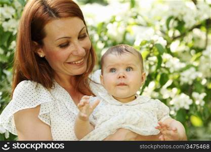 Mother and daughter close up portrait on flower background