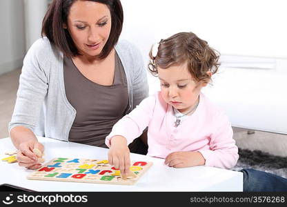 Mother and daughter completing a letter puzzle