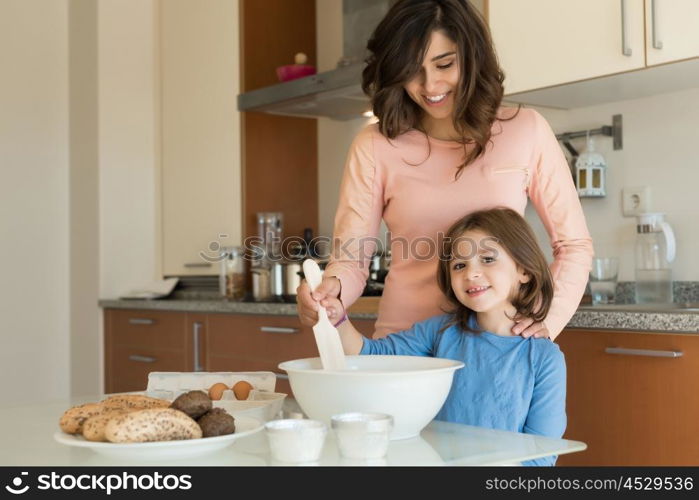 Mother and daughter cooking in the kitchen