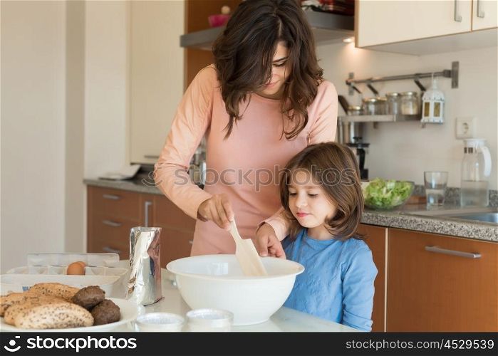 Mother and daughter cooking in the kitchen